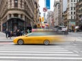 Motion blur of yellow taxi cab speeding through an intersection on 23rd Street in New York City Royalty Free Stock Photo