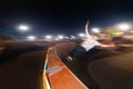 Motion in blur young skater is rolling down the ramp at night in a skate park. Flash technique with wiring movement Royalty Free Stock Photo