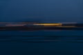 Motion blurr of industry background with defocused cargo dock terminal in sea with colorful bokeh lights at midnight