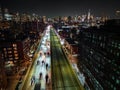 Motion blurred aerial shot of traffic on busy multilane expressway in night metropolis. Downtown skyscrapers in Royalty Free Stock Photo