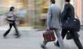 Motion blurred business people walking on the street Royalty Free Stock Photo