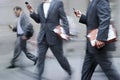 Motion blurred business people walking on the street Royalty Free Stock Photo