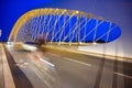 Motion blurred cars and cyclist cross The Troja Bridge, Prague, Czech Republic at night Royalty Free Stock Photo