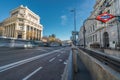 Motion blurred cars and people at Banco de Espana (Central Bank) subway station in Alcala street downtown Madrid