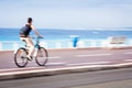 Motion blurred cyclist going fast on a city bike lane