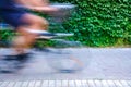 Motion blurred cyclists to show speed, driving along a bike lane, and make transport and urban displacements more sustainable Royalty Free Stock Photo