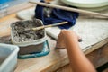 Motion blurred hands of girl molding the clay work with wet mud in plastic tray