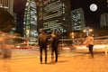 Motion blurred light in the city downtown night skyline full moon and people walking street at Shinjuku Tokyo Japan