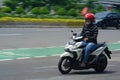Motion Blurred panning photo of moving motorcycle on the thr street. Jakarta, Indonesia. April 20, 2023.