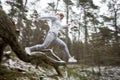 Motion blurred photo of woman exercising in forest in winter