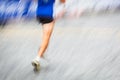 Motion blurred runner's feet in a city environment Royalty Free Stock Photo