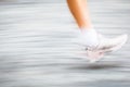Motion blurred runner's feet in a city environment Royalty Free Stock Photo