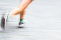 Motion blurred runner's feet in a city environment Royalty Free Stock Photo