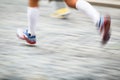 Motion blurred runner's feet in a city environment Royalty Free Stock Photo