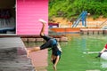 Motion of boy jumping into the lake from the deck Royalty Free Stock Photo