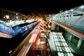 Motion lights of speeding cars on the bright street of night city Royalty Free Stock Photo