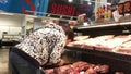 Motion of people buying meat at fresh meat section