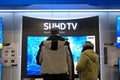 Motion of people looking new tv inside store