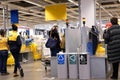 Motion of people paying product at self check out counter inside Ikea store