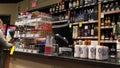 Motion of people paying wine at check out counter inside liquor store