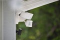 Motion sensor with light detector mounted on exterior wall of private house as part of security system Royalty Free Stock Photo