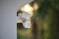 Motion sensor with light detector mounted on exterior wall of private house as part of security system Royalty Free Stock Photo