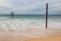 Motion wave hitting ruin decay wooden bridge at Pilai beach