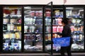 Motion of woman buying frozen fruits inside Walmart store Royalty Free Stock Photo