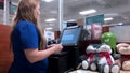 Motion of woman buying hairball paste at check out counter inside PetSmart store