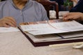 Motion of woman looking at menu inside Chinese restaurant