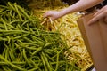 Motion of woman`s hand picking yellow bean inside superstore