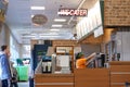 Motion of worker preparing sandwich for customer inside subway restaurant