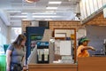 Motion of worker preparing sandwich for customer inside subway restaurant