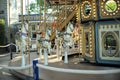 Motioned blurred picture of horse of the carousel with defocused horses and bokeh lights in background