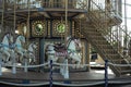 Motioned blurred picture of horse of the carousel with defocused horses and bokeh lights in background