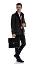 Motivated businessman holding a briefcase and looking away Royalty Free Stock Photo