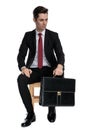 Motivated businessman holding his briefcase and looking away