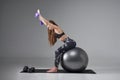 Motivated fitness woman working out on pilates ball. Royalty Free Stock Photo