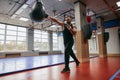 Motivated guy training with punching speed ball