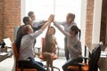 Motivated happy diverse office people group giving high five