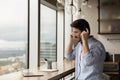 Motivated male student putting headphones on learning foreign language online