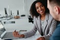 Motivated positive female leader talking with male coworker explaining project and plans at workplace Royalty Free Stock Photo