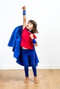 Motivated super hero kid showing strength and imagination, reaching success