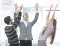 Motivated young business team pledging support raising their hands Royalty Free Stock Photo