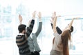 Motivated young business team pledging support raising their hands Royalty Free Stock Photo