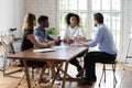 Motivated young mixed race business people discussing project. Royalty Free Stock Photo