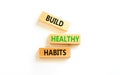 Motivation and Build healthy habits symbol. Concept words Build healthy habits on wooden block on a beautiful white table white Royalty Free Stock Photo