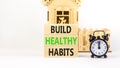 Motivation and Build healthy habits symbol. Concept words Build healthy habits on wooden block on a beautiful white table white Royalty Free Stock Photo