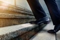 Motivation and challenging Career Concept. Steps Forward into a Success. Low Section of Businessman Walking Up on Staircase Royalty Free Stock Photo