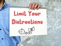 Motivation concept about Limit Your Distractions with sign on the piece of paper